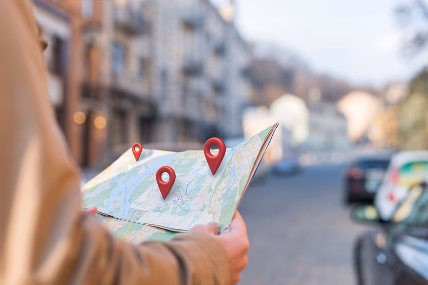 Person holding a map with digital red location markers overlaid, standing on a city street.